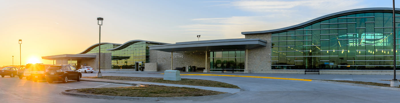 large modern glass building at sunset