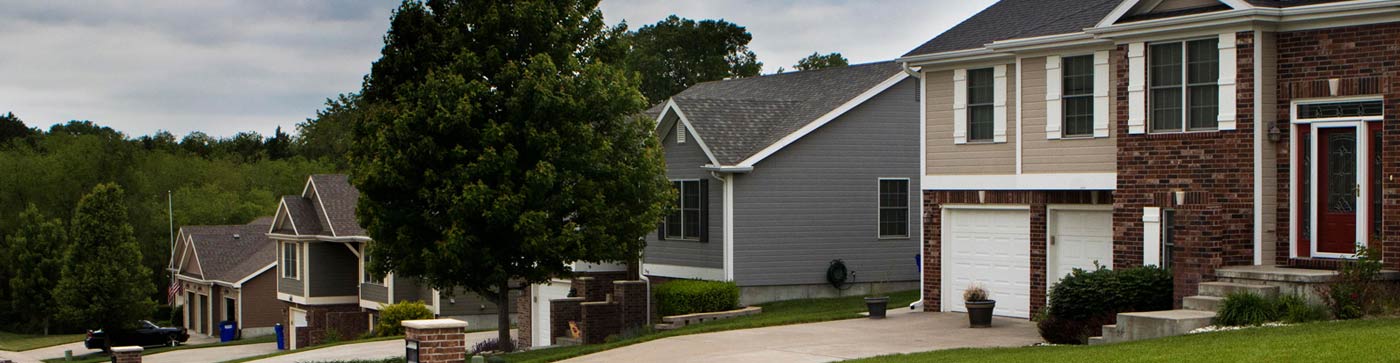 Junction City neighborhood street, house and trees